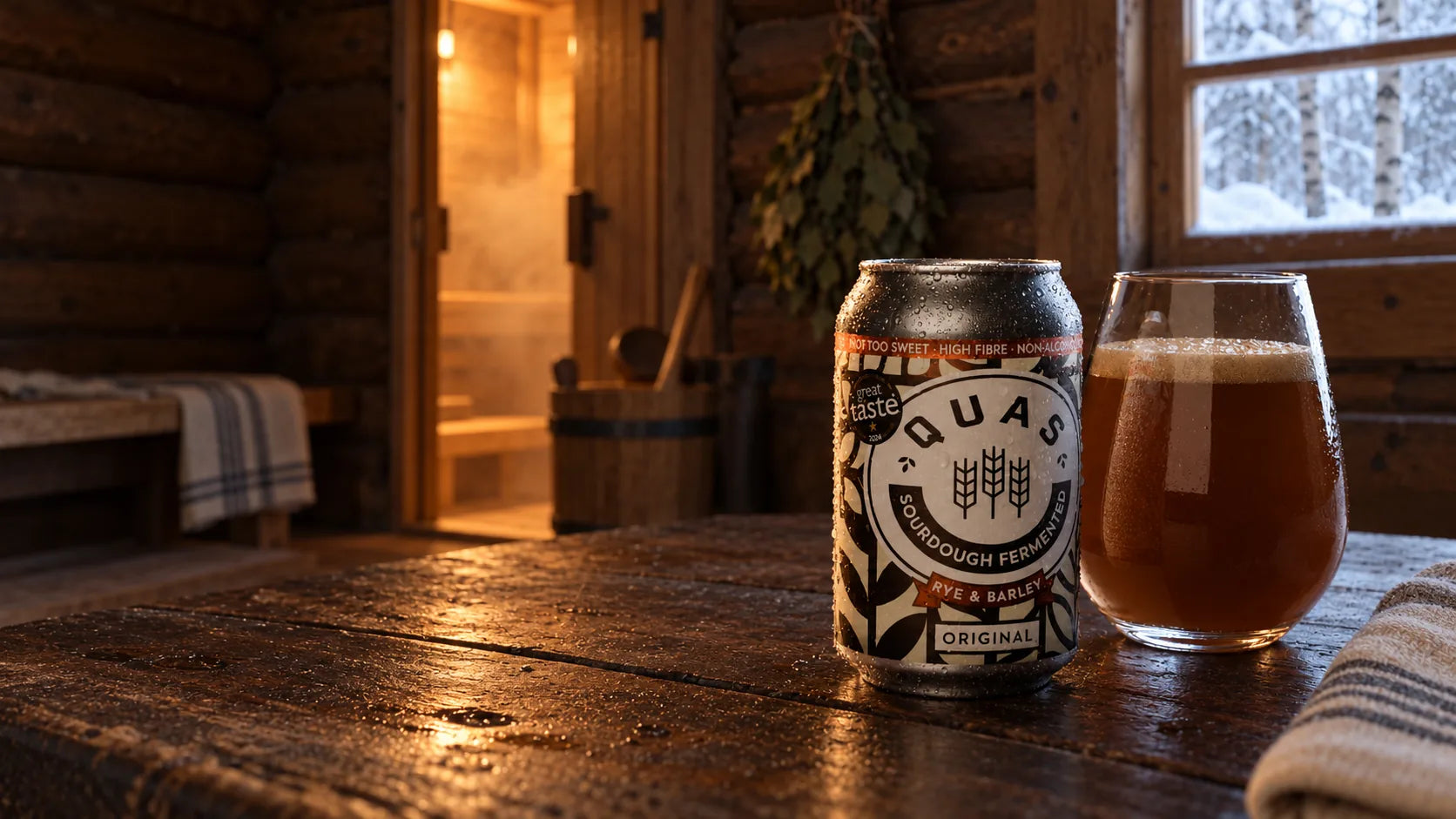 Cold Quas Original and a tulip tumbler of kvass in a timber banya resting room.